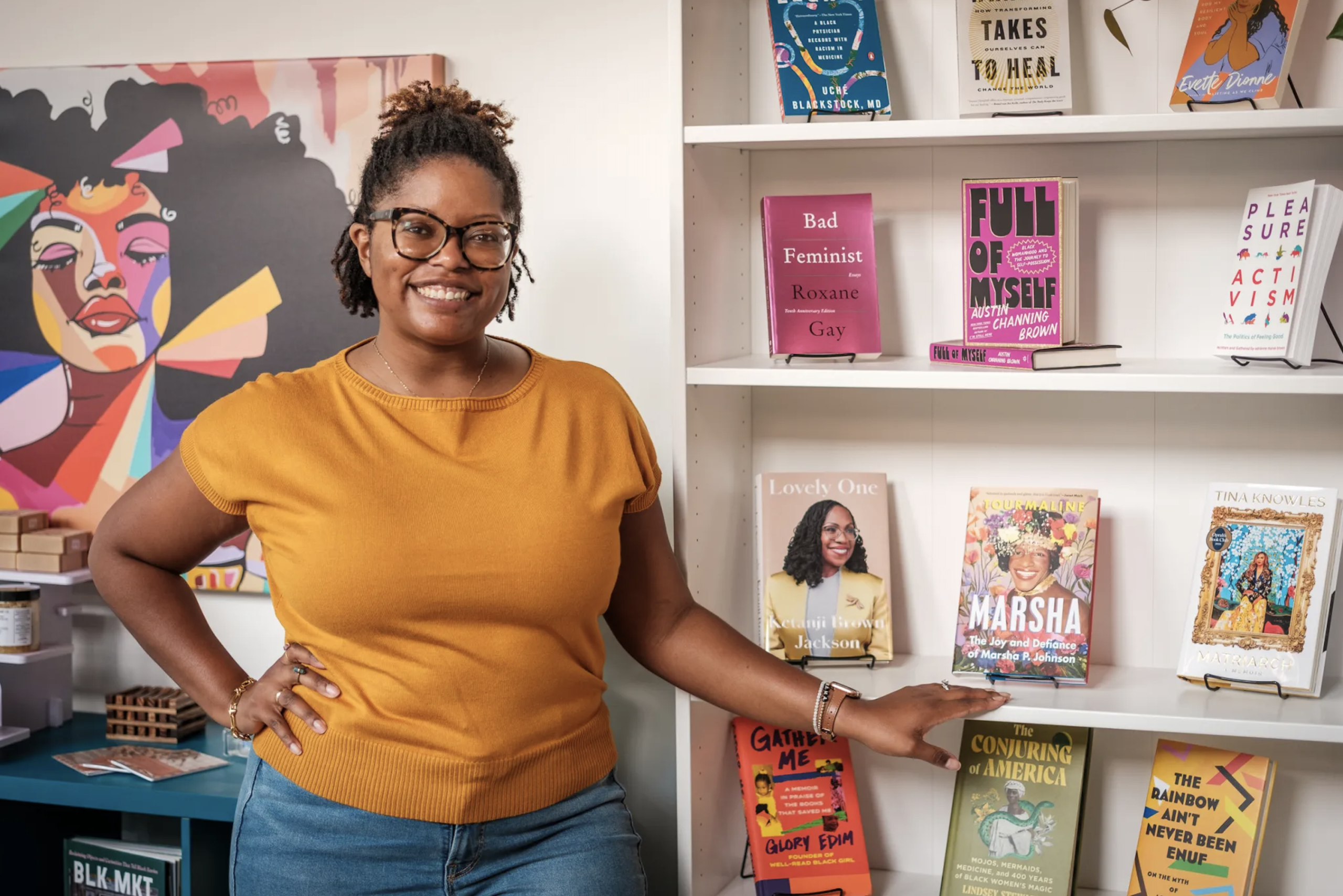 Zora's Place founder Thompson Payton standing by books