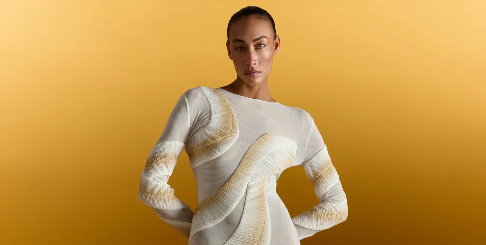 Woman wearing cream textured long-sleeve top against yellow background
