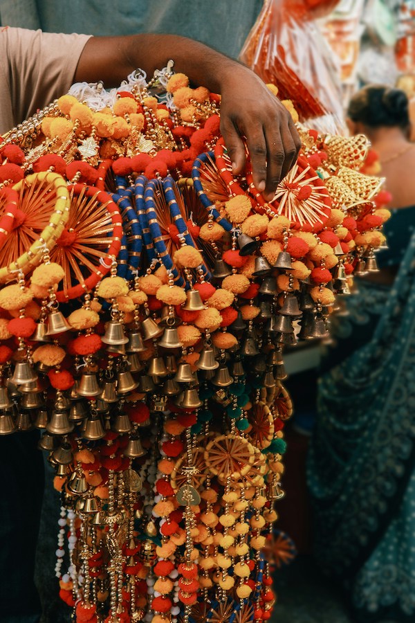 Ornate traditional Indian wedding jewelry with bells, beads, and orange decorations