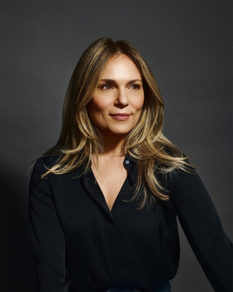 Headshot of Erika Burke Rossa against a dark grey background.