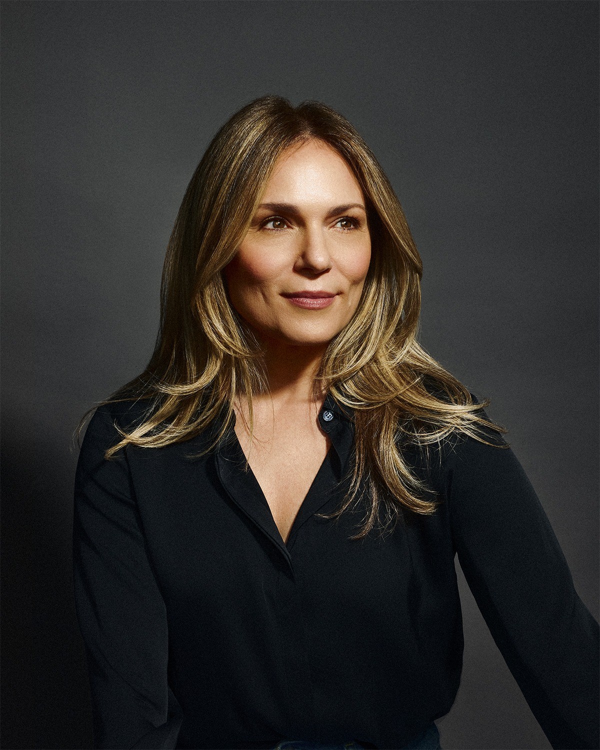 Headshot of Erika Burke Rossa against a dark grey background.