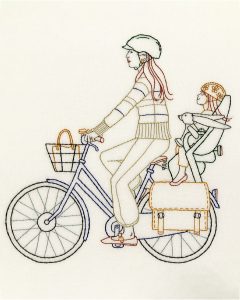 Multicolored embroidered image of a mother and her daughter on a bike.