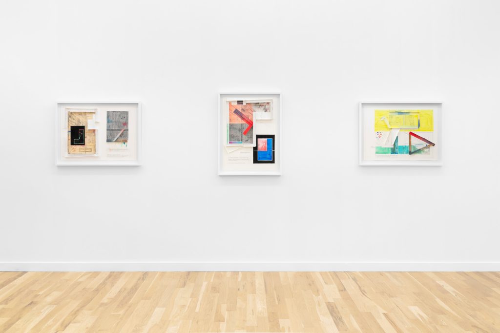 image of three small brightly colored paintings on a gallery wall