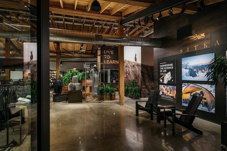 Image of a hunting supply store, with dark wood and greenery