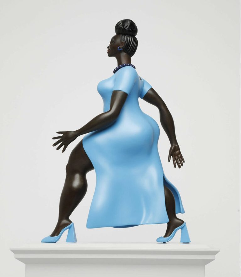 Large sculpture of a Black woman, mid-stride, wearing a blue dress